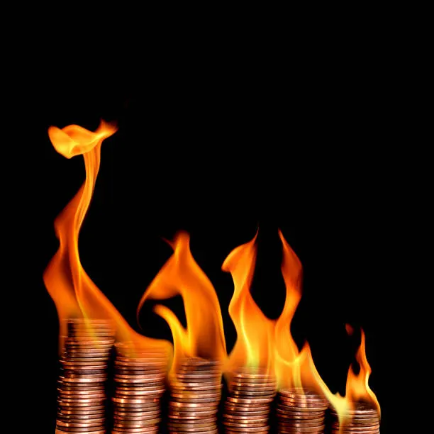 Stacks of coins on fire representing unchecked AI subscription and token spend